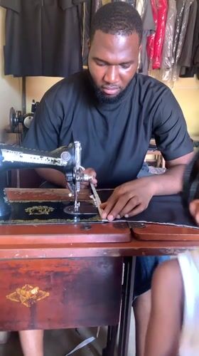 Daily life unfolds in Nigerian neighborhood, sewing and schoolchildren
