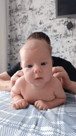 Baby with caregiver observed on bed in Andreyevo