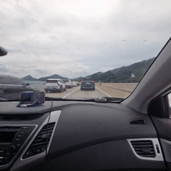 Highway traffic jam in Jinbu-myeon under cloudy mountain skies