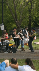 Three-piece band performs outdoor concert in London park