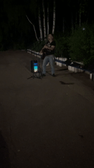 Street musician performs nighttime guitar set in Chaikovsky, Russia