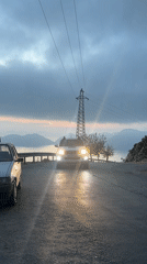 White pickup truck drives past with headlights in Fethiye