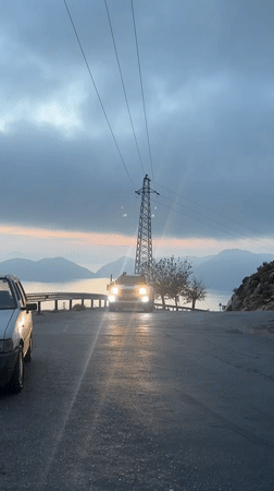 White pickup truck drives past with headlights in Fethiye