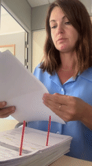 Sorting through paper documents at a desk in rural France
