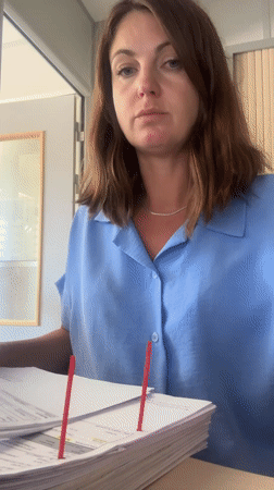 Sorting through paper documents at a desk in rural France
