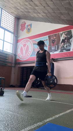 Athlete trains with weights at Poltava sports facility
