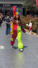 Clown-costumed person walks past children playing in Çekmeköy
