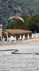Paraglider performs tricks over Fethiye beach in Turkey