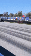 Car races on sunny track in Riga with spectators