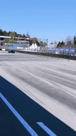 Car races on sunny track in Riga with spectators
