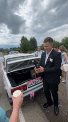 Champagne popped at a ribbon-decorated wedding car in Russia