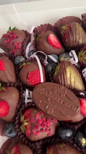 Person samples decorated chocolate strawberries in Birobidzhan gift box