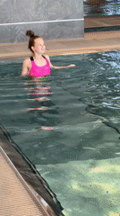 Girl swimming with flotation devices in Chaikovsky pool