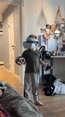 Boy plays VR game, peony blooms in Veliky Novgorod