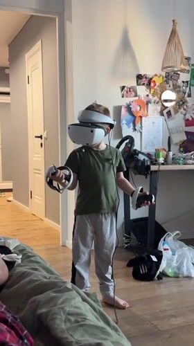 Boy plays VR game, peony blooms in Veliky Novgorod