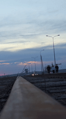 Woman photographs herself on railway tracks in Chaikovsky, Russia