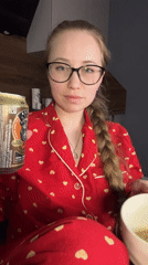 Woman in heart pajamas holds drink can in Saint Petersburg