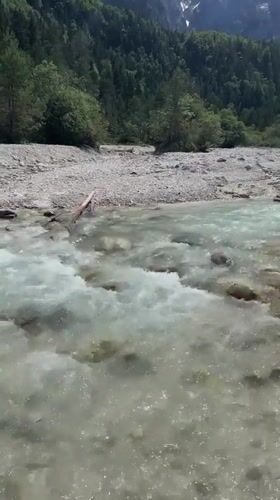 Clear river flows through Alpine landscape in Slovenia