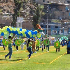 Community parade held on sports field in Mariano Melgar Peru