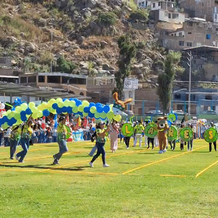 Community parade held on sports field in Mariano Melgar Peru