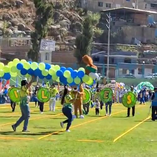 Community parade held on sports field in Mariano Melgar Peru