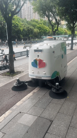 Autonomous sidewalk sweeper rolling through Baiyun District, Guangzhou