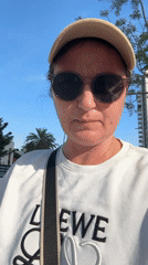 Woman in Loewe sweatshirt rides electric scooter in Netanya