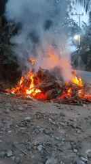 Leaf fire and smoke near Lhokseumawe at dusk