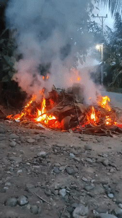 Leaf fire and smoke near Lhokseumawe at dusk