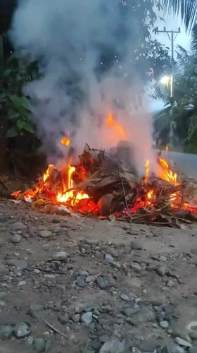 Leaf fire and smoke near Lhokseumawe at dusk