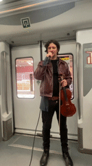 Violinist performs live music on train in Barcelona area