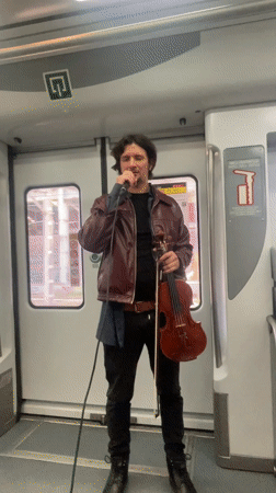 Violinist performs live music on train in Barcelona area