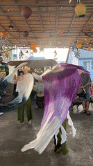 Traditional fan dance performance captured at outdoor cultural event in Sochi