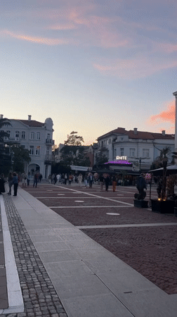 Evening crowd gathers in Blagoevgrad plaza at sunset