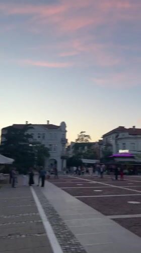 Evening crowd gathers in Blagoevgrad plaza at sunset