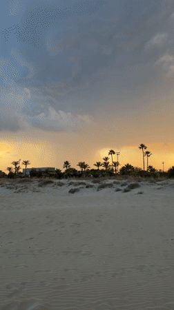 Sunset stroll along Grao's beachfront boardwalk with an electric scooter