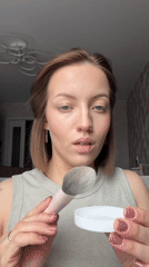 Woman applies makeup in morning routine, Reshetnikovo Russia