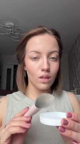 Woman applies makeup in morning routine, Reshetnikovo Russia