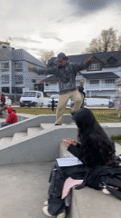 Skateboarder practices tricks on concrete steps in Ushuaia park