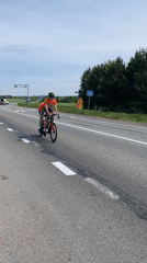 Tandem cyclists pass road work in Перевозное, Russia