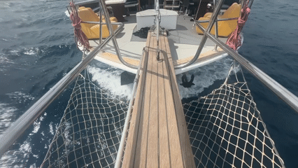 Boat travels through Turkish waters with wooden bow deck
