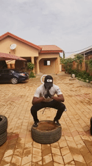 Man exercises with tires, makeshift weights in Nigeria courtyard