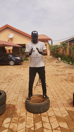 Man exercises with tires, makeshift weights in Nigeria courtyard
