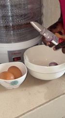 Henna-decorated cook prepares meal, displays clothing in Ado Nigeria