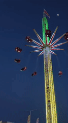 Night carnival operates with illuminated rides, crowds gather at dusk