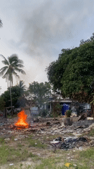 Fire burns through debris in rural Thai village