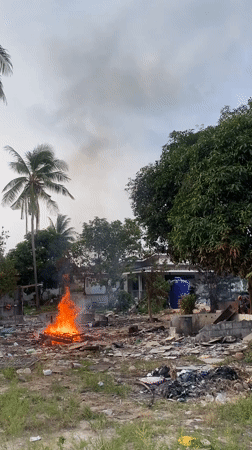 Fire burns through debris in rural Thai village