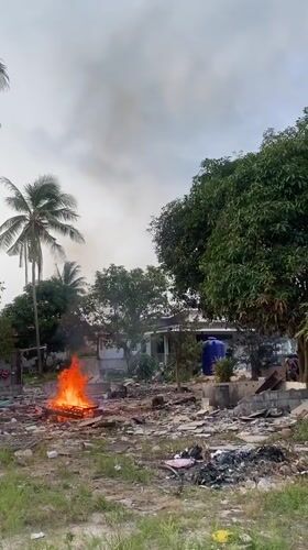 Fire burns through debris in rural Thai village
