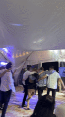 Baby shower celebration with dancing under colored lights in Пакли
