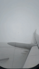Passenger films cloudy aerial view from airplane over Georgia